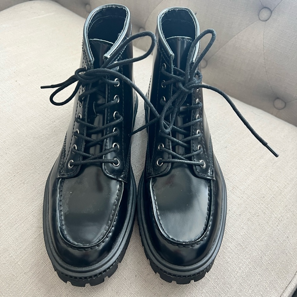 Leather upper, synthetic sock lining. Worn once. Express 9.5 men’s black boots.